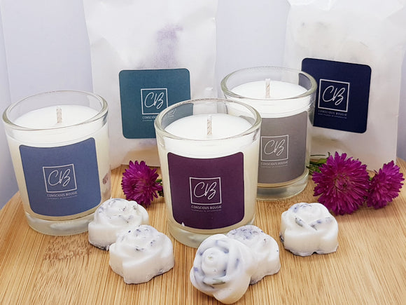Three white candles in a glass jar, five rose shaped wax melts, two packs of wax melts, decorated with flowers