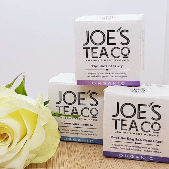 Three boxes each with a different flavour of organic tea, decorated with a flower