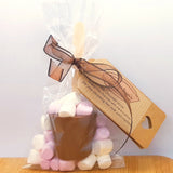 A hot chocolate stirrer with mini marshmallows in packaging with a Nellie-Jean's label