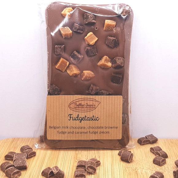 A slab of handmade Belgian milk chocolate with chocolate brownie fudge and caramel fudge pieces, in a labelled wrapper