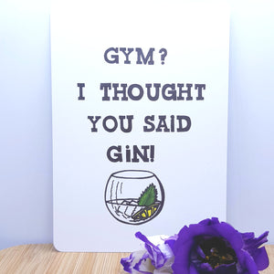 An A5 card showing a glass of gin with Gym? I thought you said gin! written on it, decorated with a purple flower in front