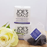 An english breakfast tea bag, two boxes of english breakfast tea, decorated with a flower