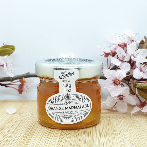 The front of a mini jar of orange marmalade