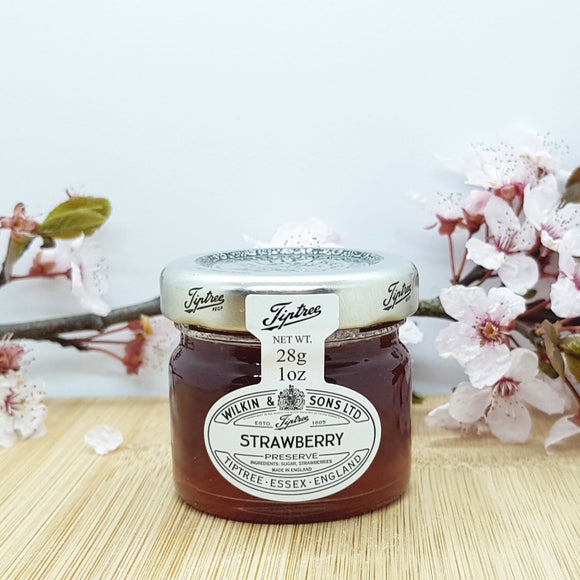 The front of a mini jar of strawberry jam