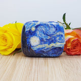 The front of a Van Gogh starry night mini mints tin, decorated with two flowers
